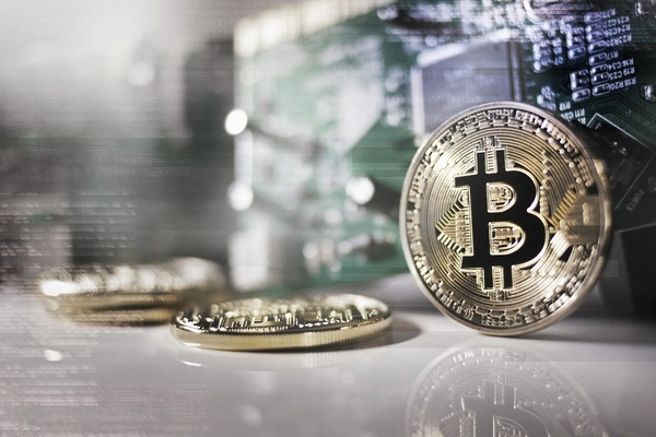 Bitcoin coin on a circuit board representing cross-chain payout